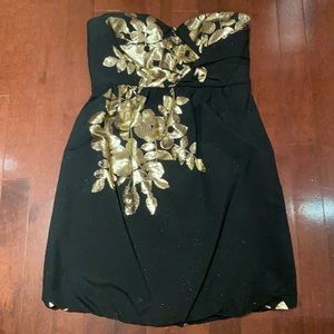 Black with gold strapless cocktail dress, gold shimmer through black under light